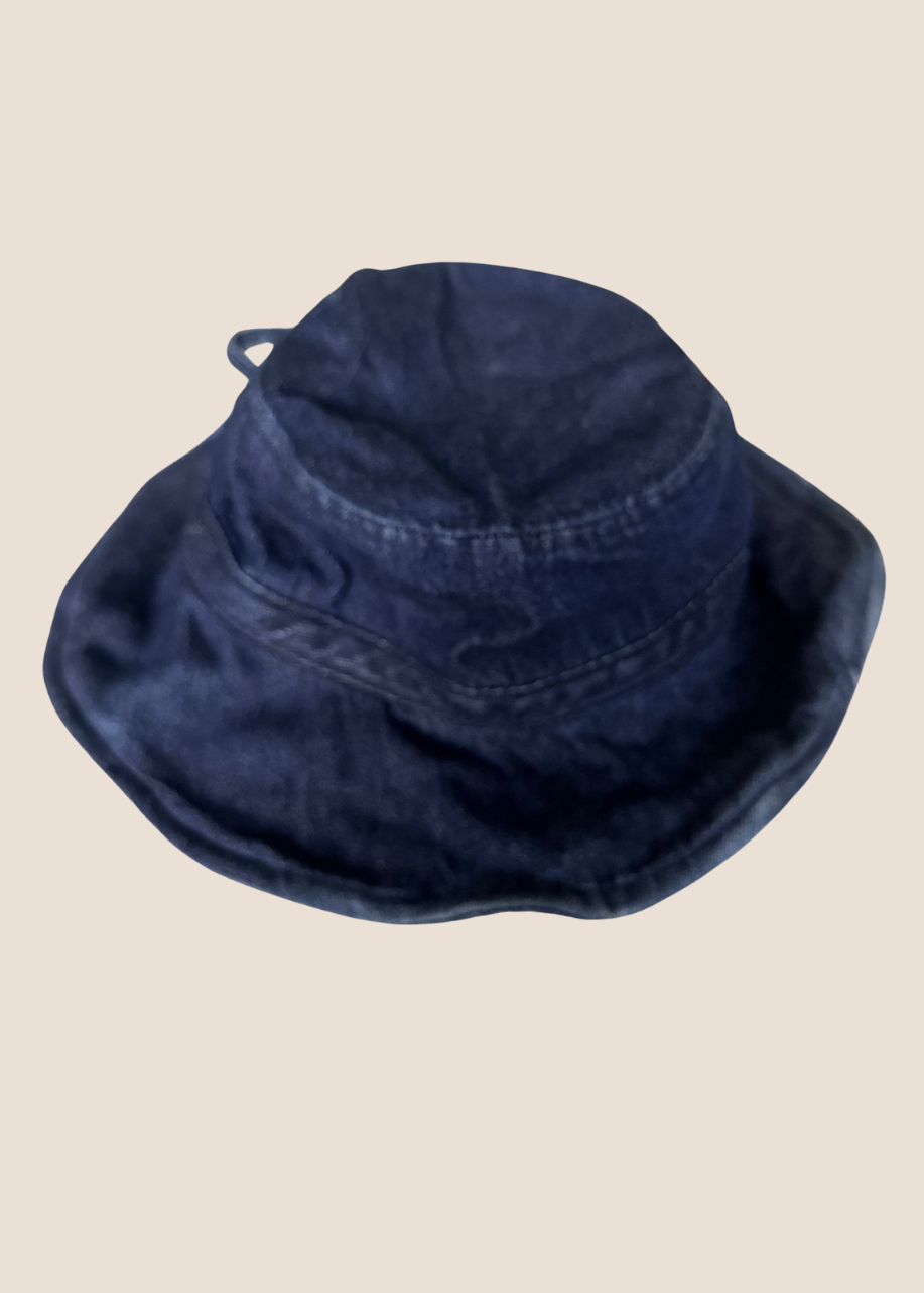 Navy blue bucket hat on a beige background